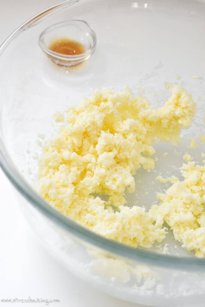 Light yellow, fluffy butter in a clear bowl