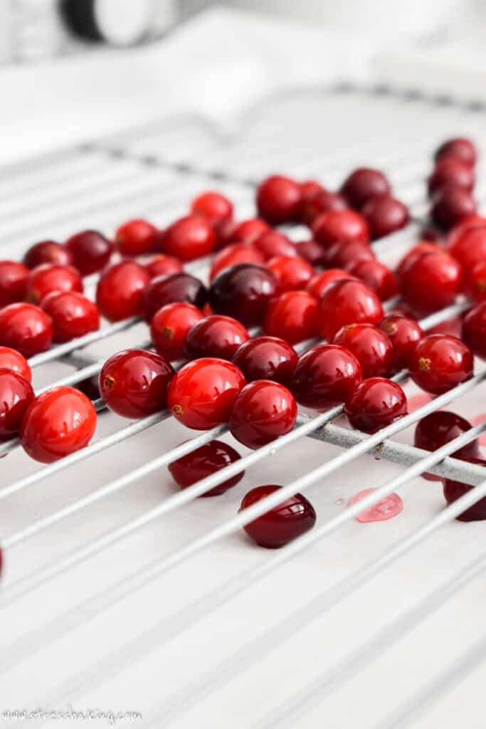 Bright red cranberries on a wire rack