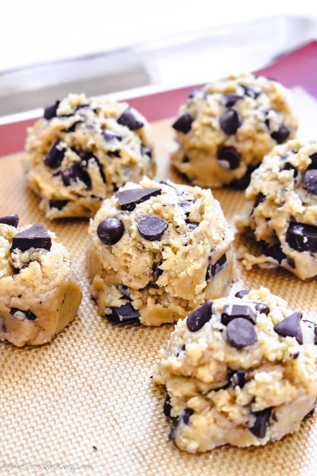 Chocolate chip cookie dough balls on a baking sheet