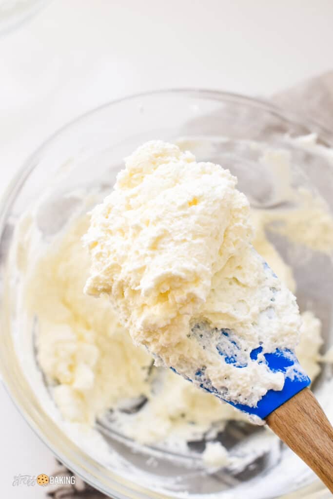 Fluffy lemon mascarpone mousse on a blue spatula