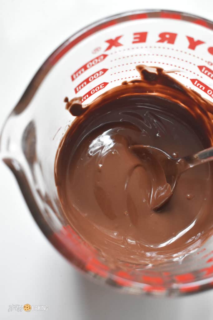 Melted chocolate in a glass measuring cup