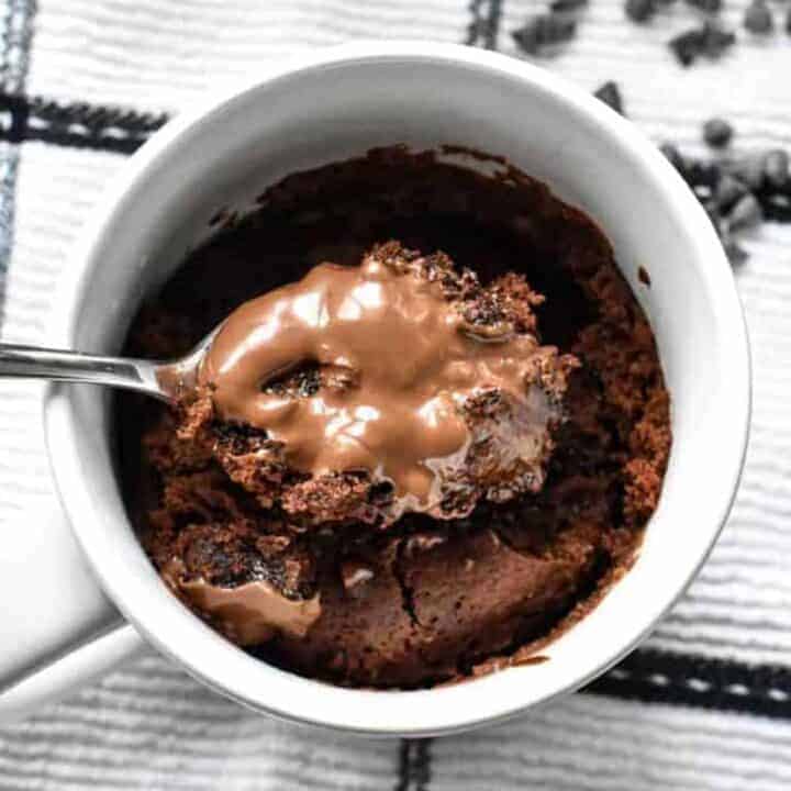Spoonful of chocolate mug cake with melted Nutella