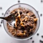 A spoonful of no bake cookie overnight oats with chocolate and peanut butter
