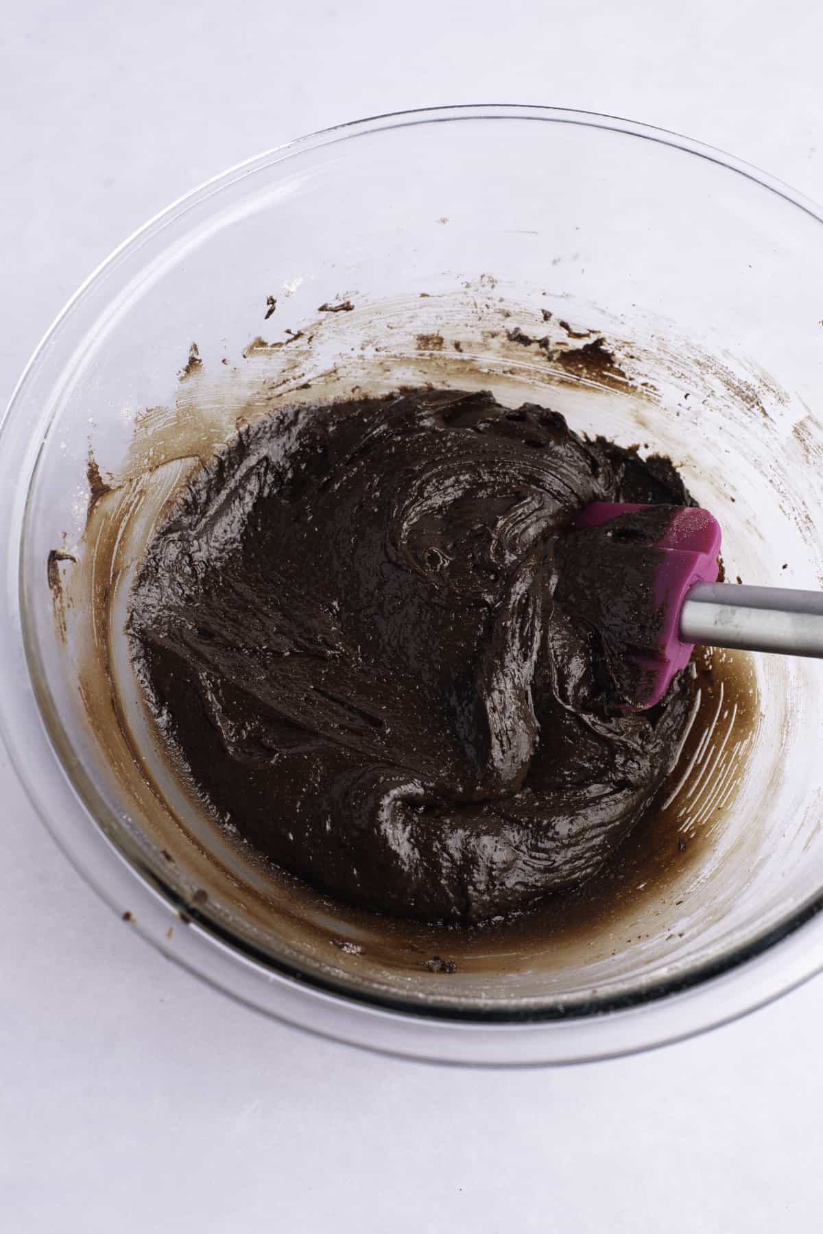 Brownie cookie chocolate batter in a clear mixing bowl
