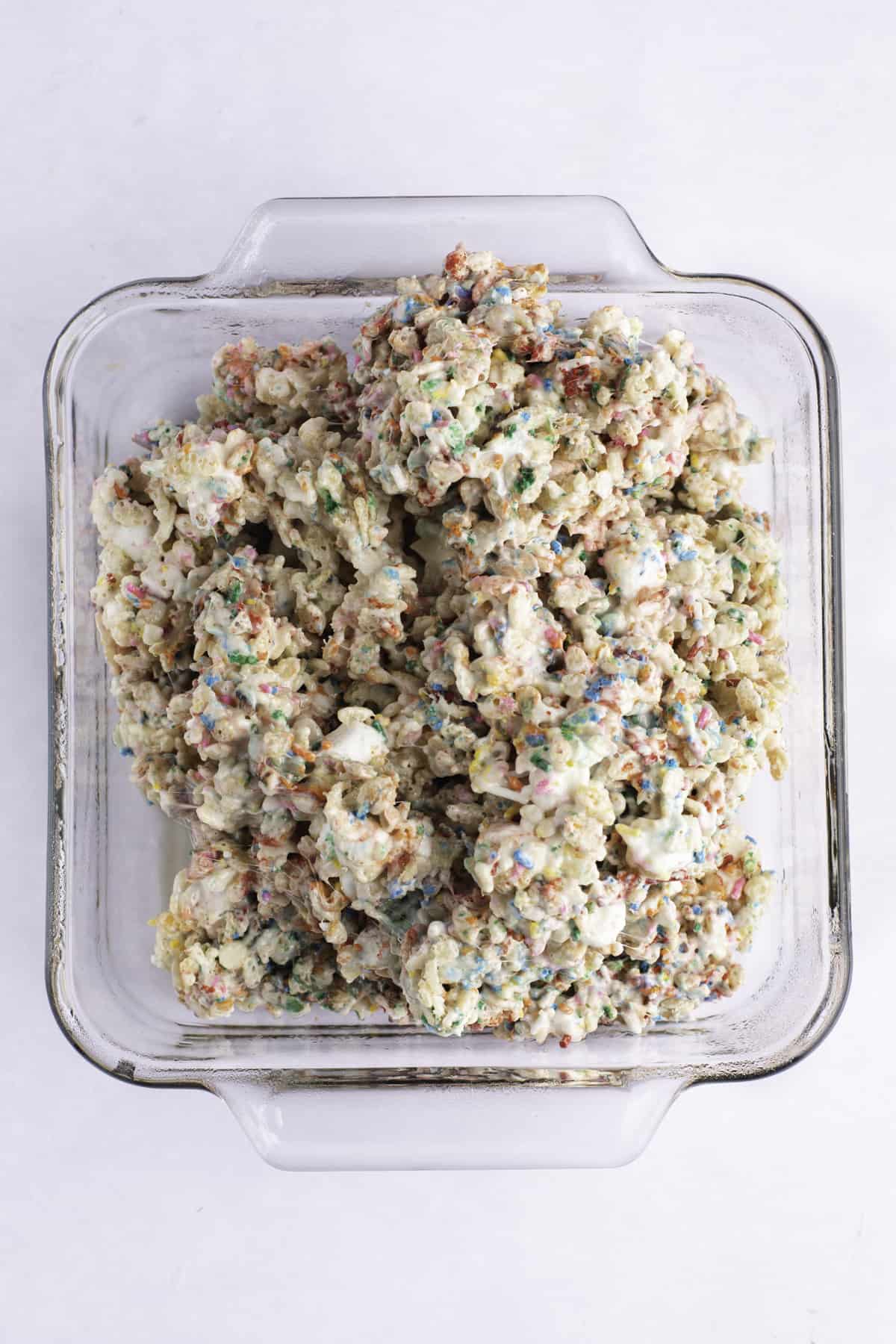 Funfetti rice krispie treat mixture being placed into a pan