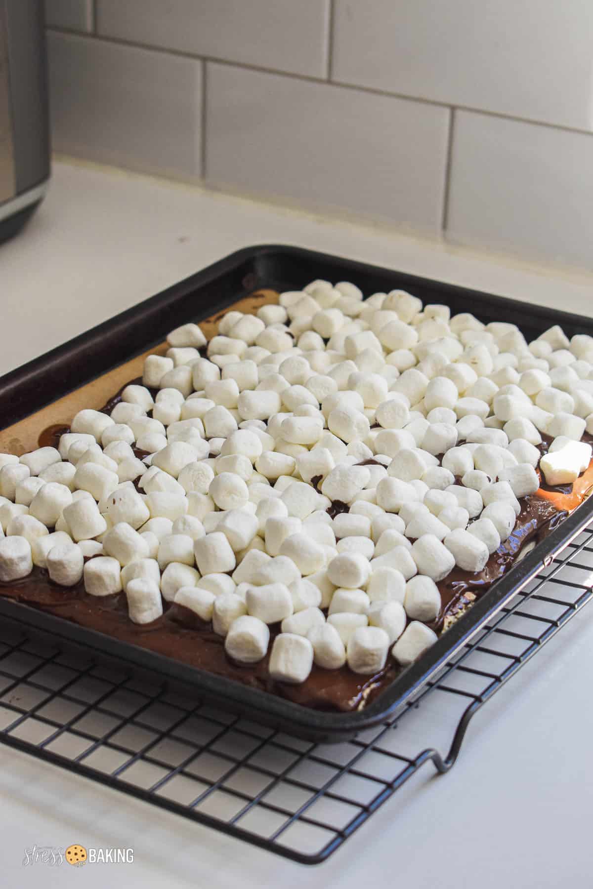 Mini marshmallows on top of melted chocolate and graham crackers