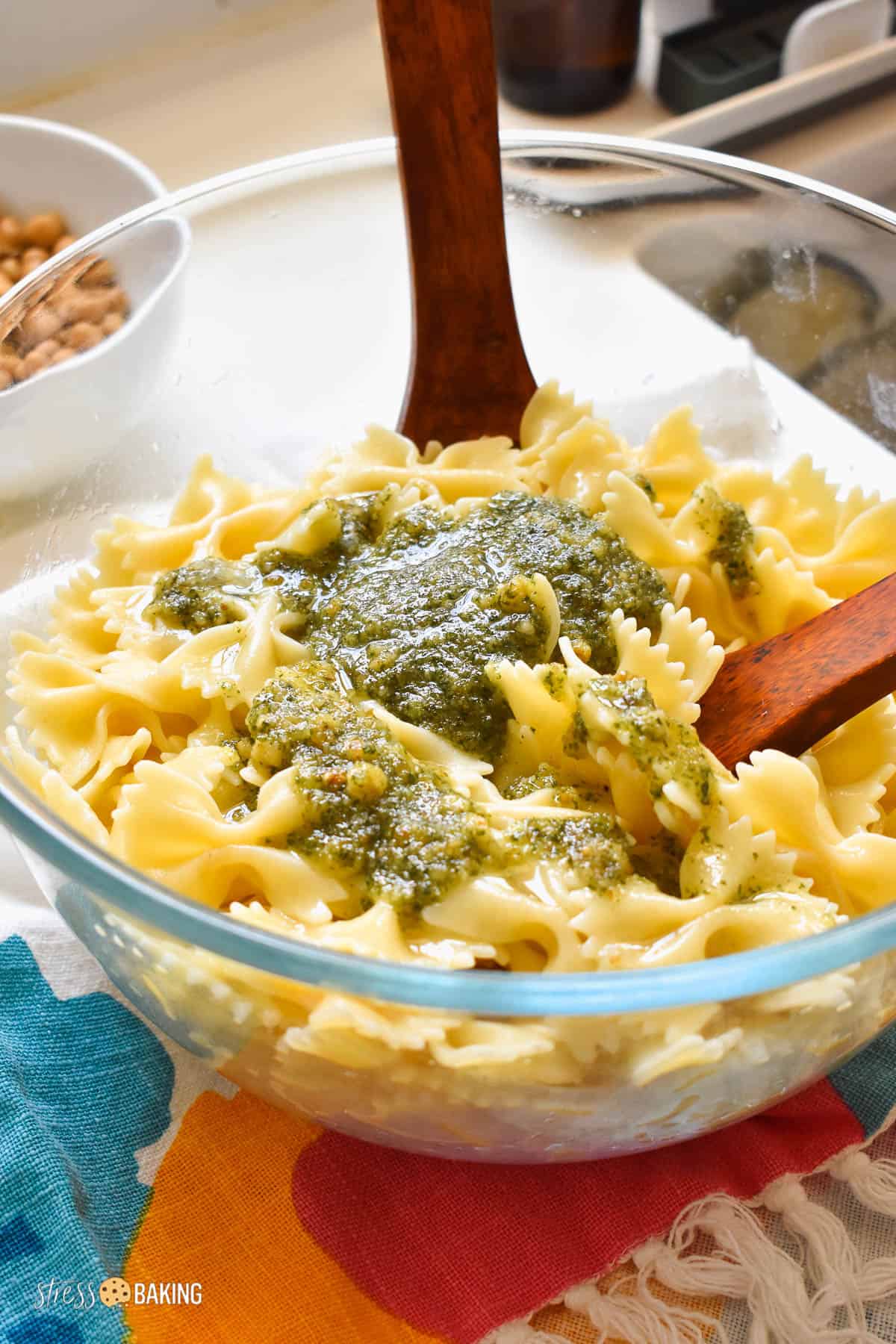 Farfalle pasta and pesto in a clear bowl