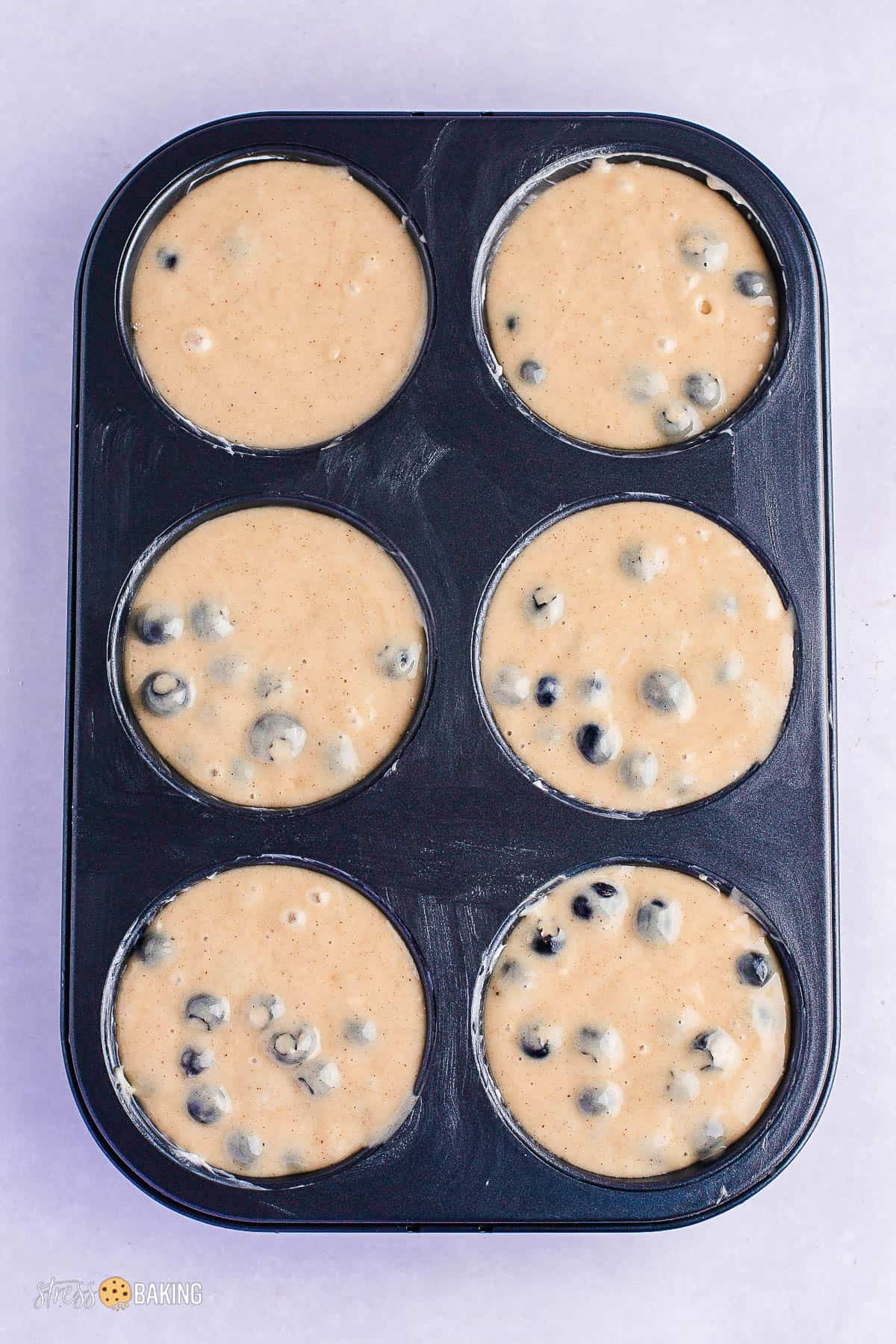 Blueberry muffin batter in a jumbo muffin pan