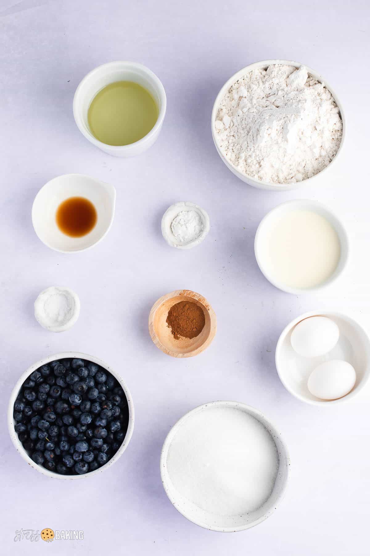 Ingredients for blueberry muffins in small bowls