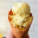 Bright yellow corn ice cream in a waffle cone