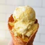 Bright yellow corn ice cream in a waffle cone