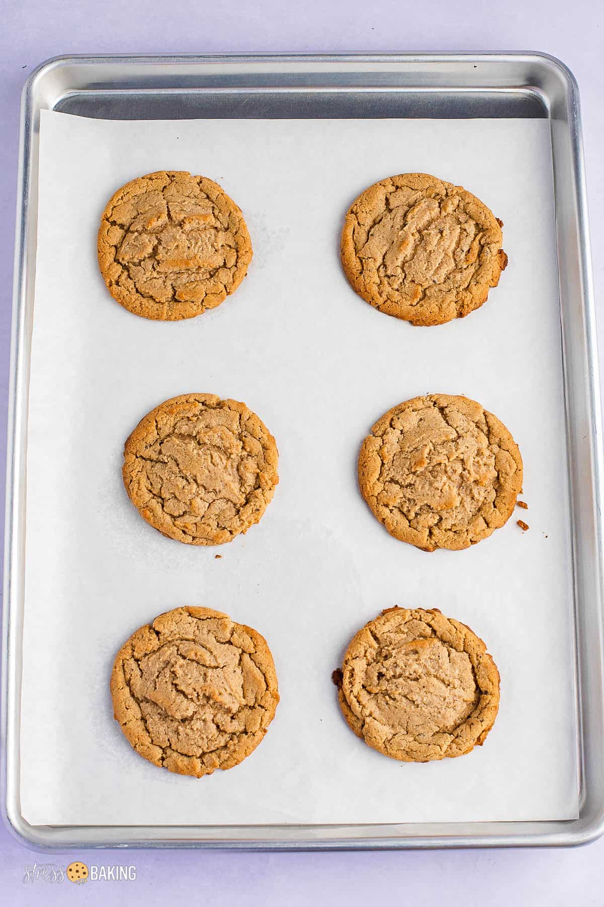 Crinkly peanut butter cookies on a baking sheet