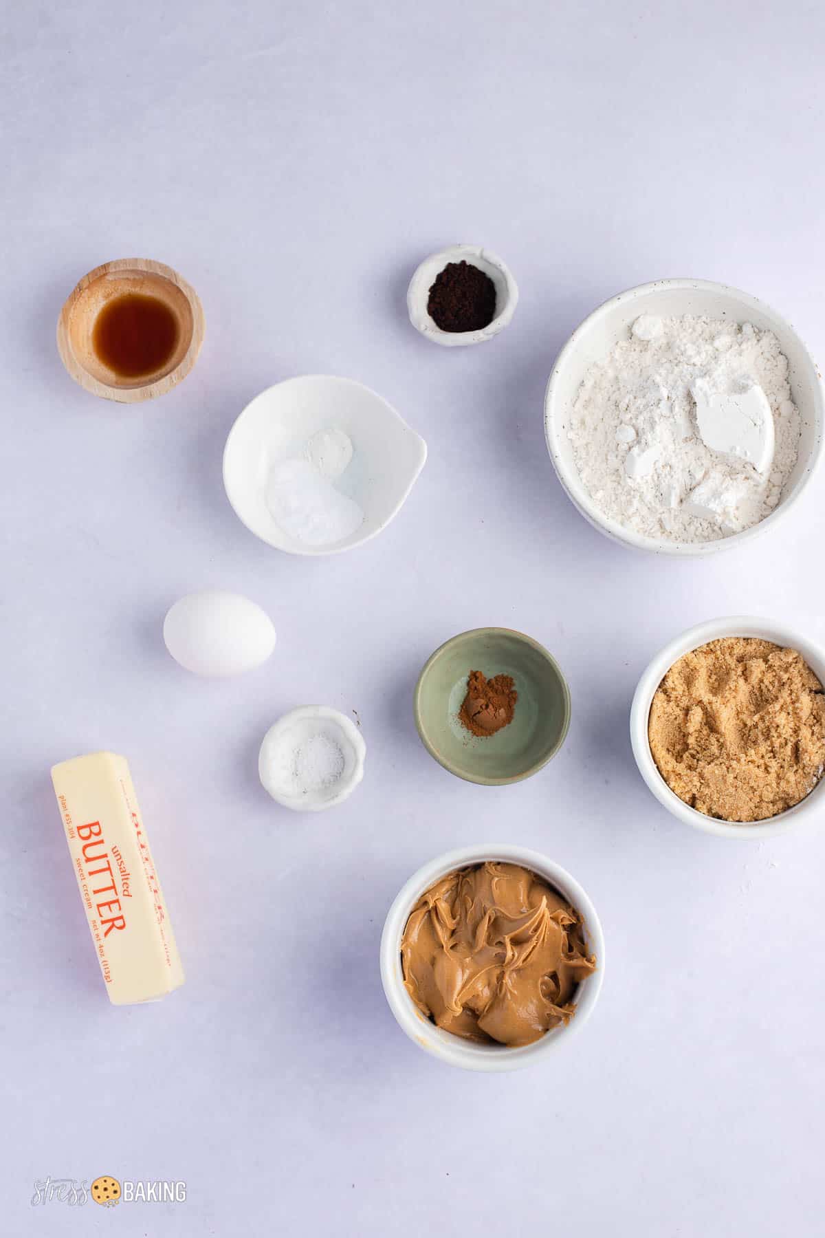 Ingredients for peanut butter espresso cookies in small bowls on a white counter