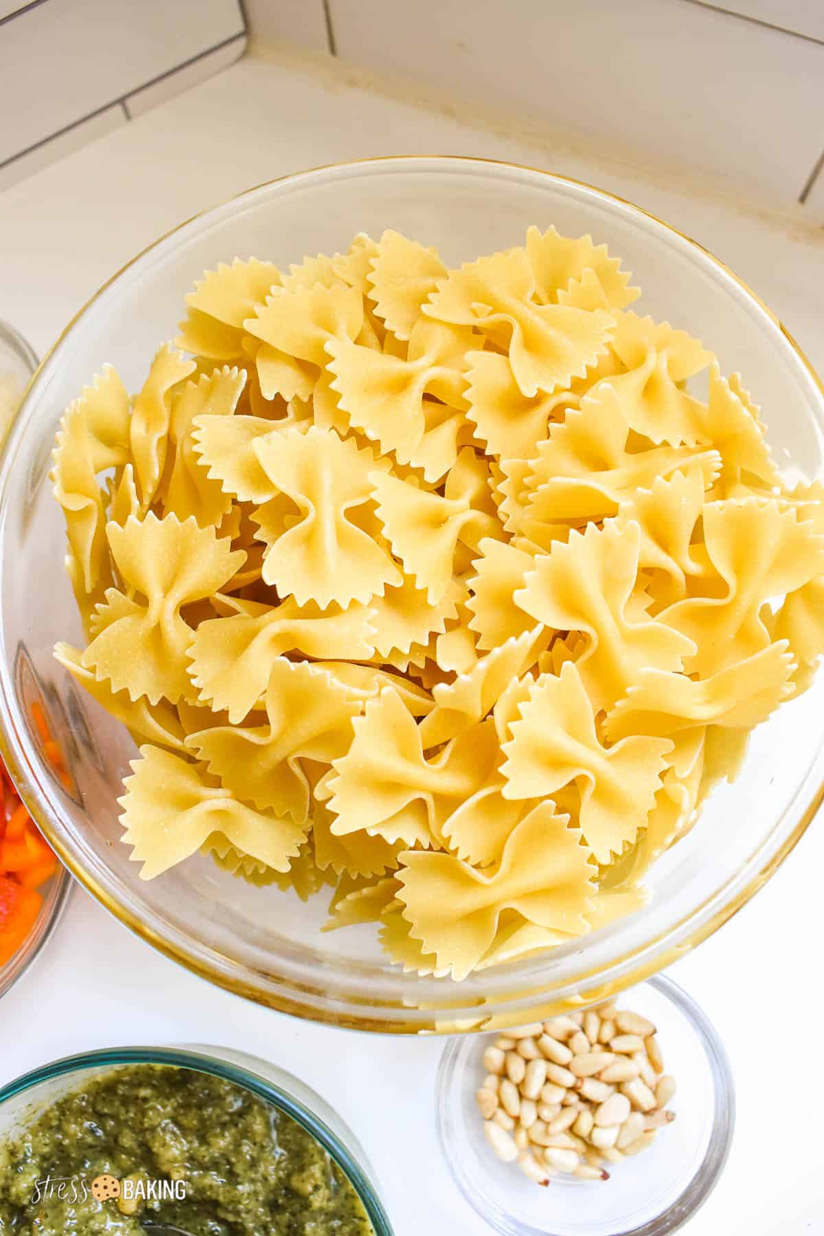 Freshly cooked farfalle pasta in a clear mixing bowl