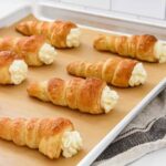 Cream horns pastries on a baking sheet