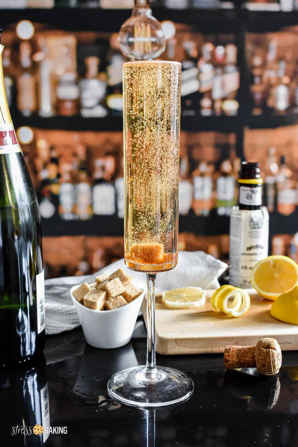Sugar cube causing bubbles in a champagne cocktail in a clear glass flute