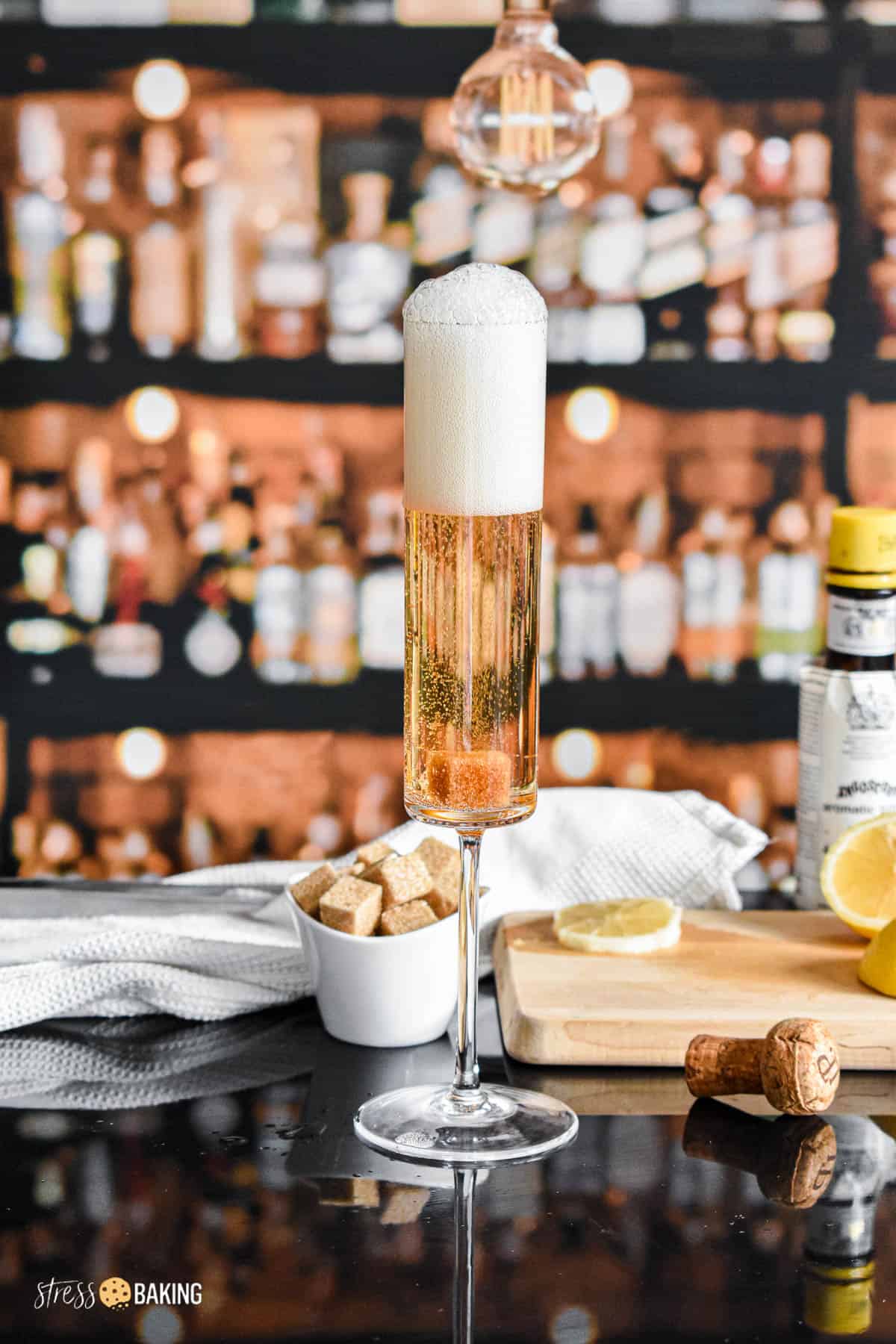 A champagne flute with freshly poured champagne bubbling up over the top