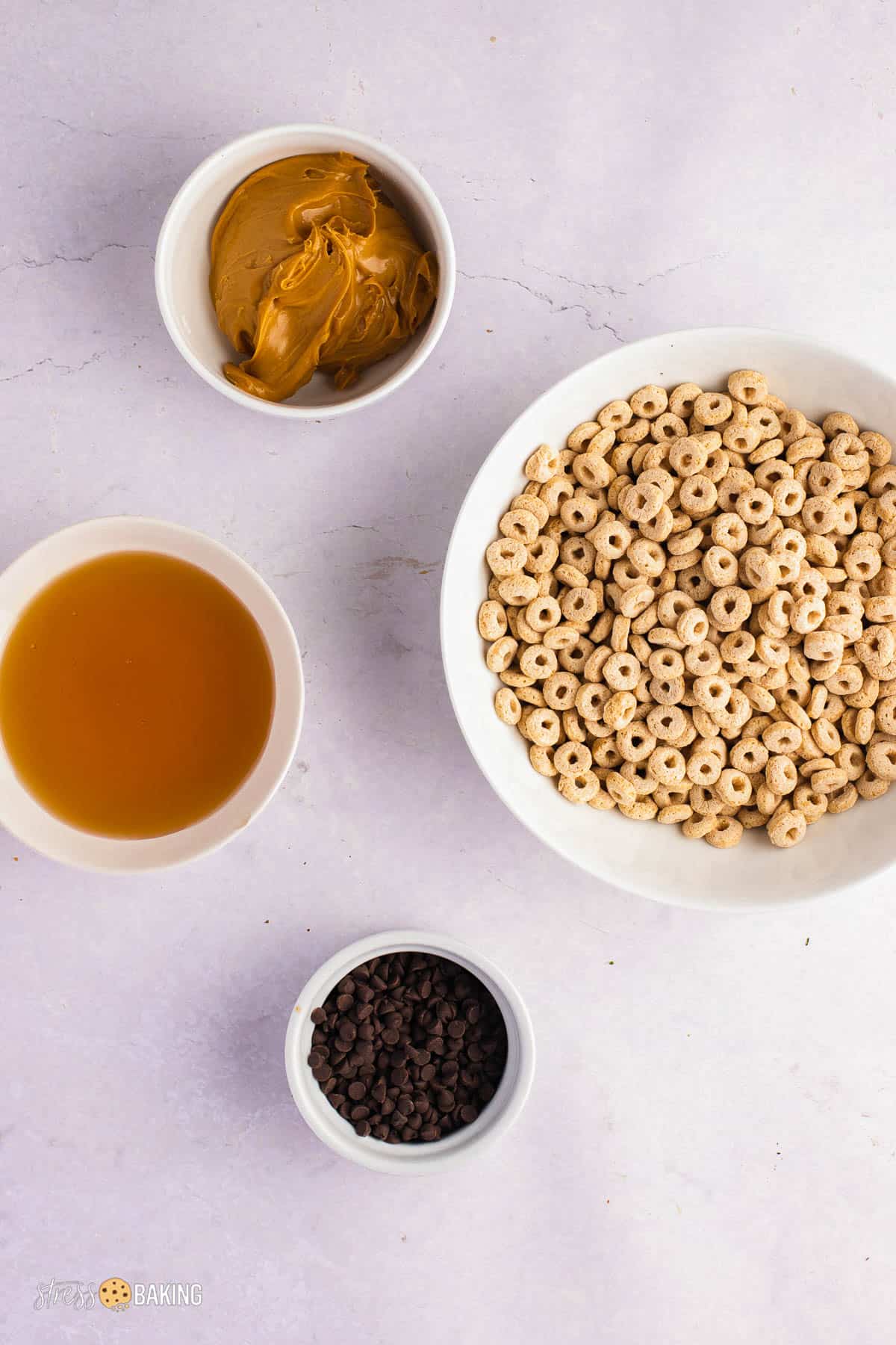 Ingredients for no bake peanut butter Cheerio bars in white bowls