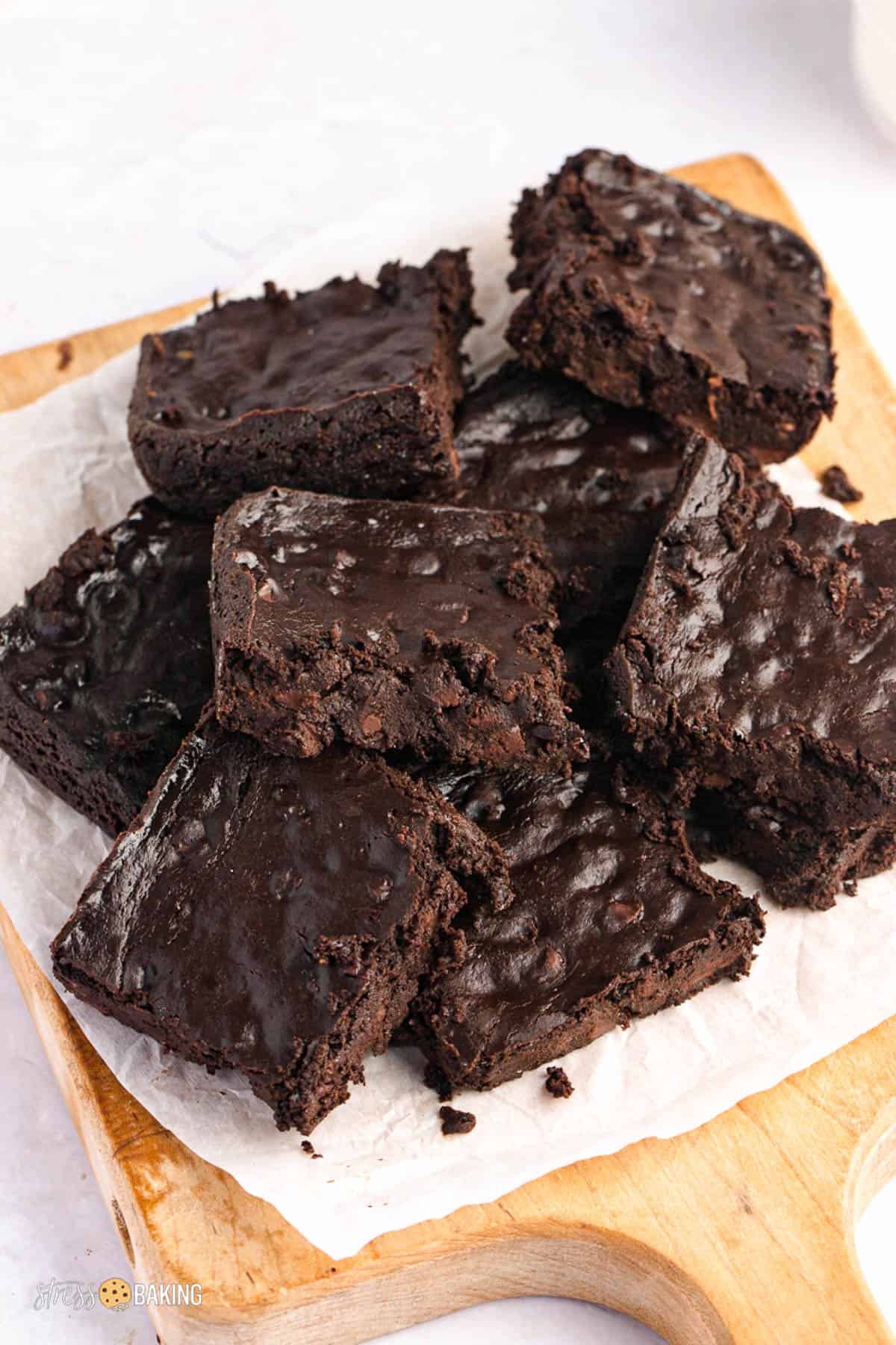 Pile of fudgy brownies on a cutting board