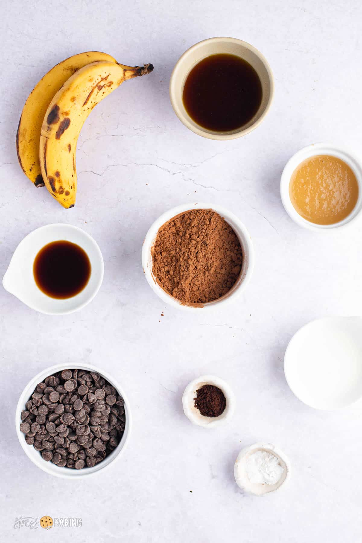 Ingredients for banana brownies in white bowls on a counter