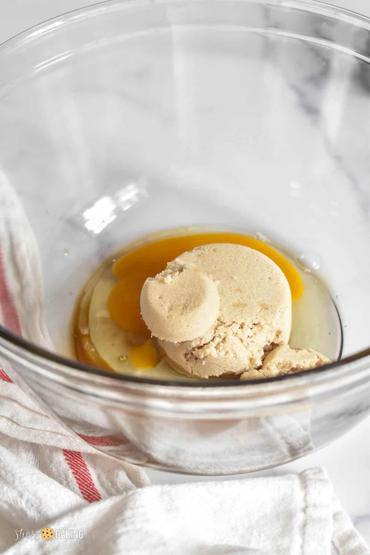 Light brown sugar and egg in a clear mixing bowl