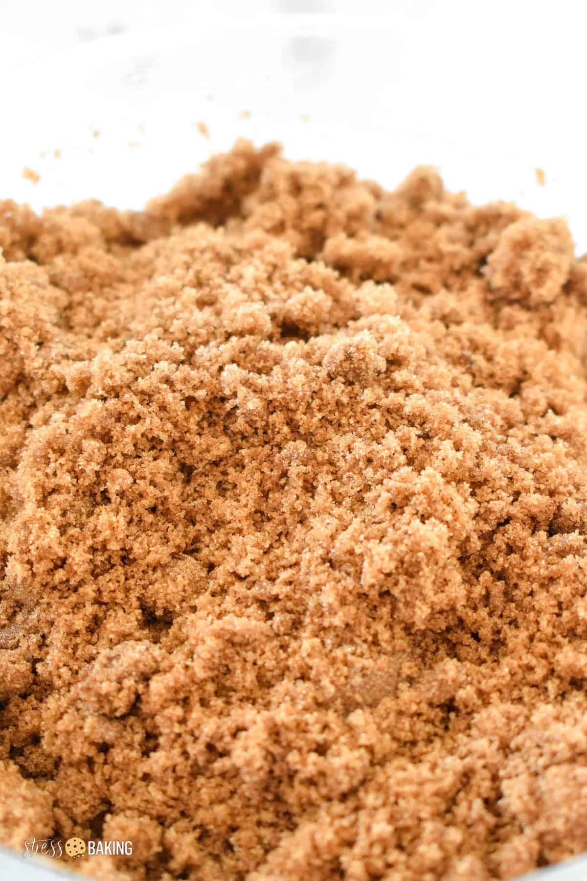 Clumped hardened brown sugar in a clear mixing bowl