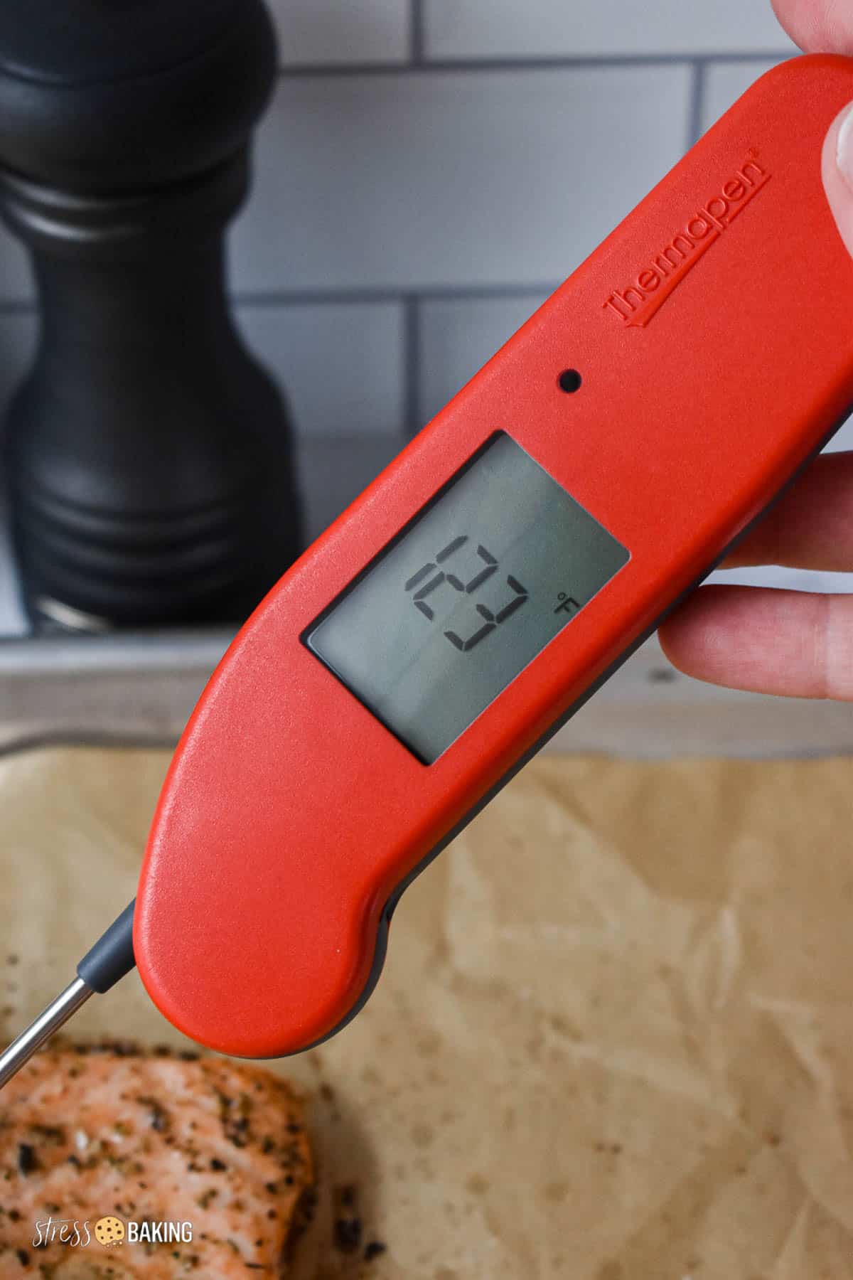 A red ThermoWorks Thermapen reading 123 degrees F