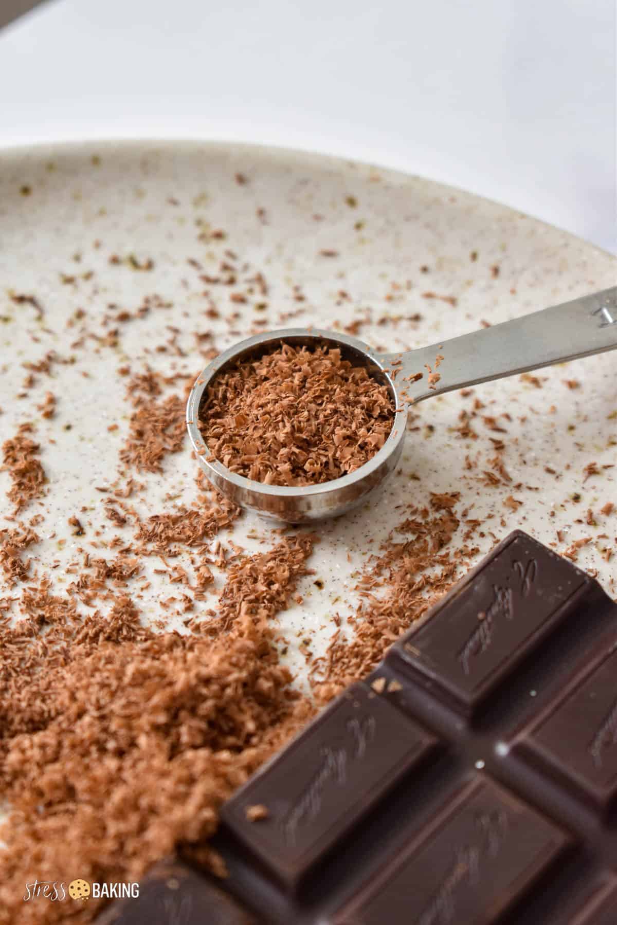 Grated chocolate in a measuring spoon