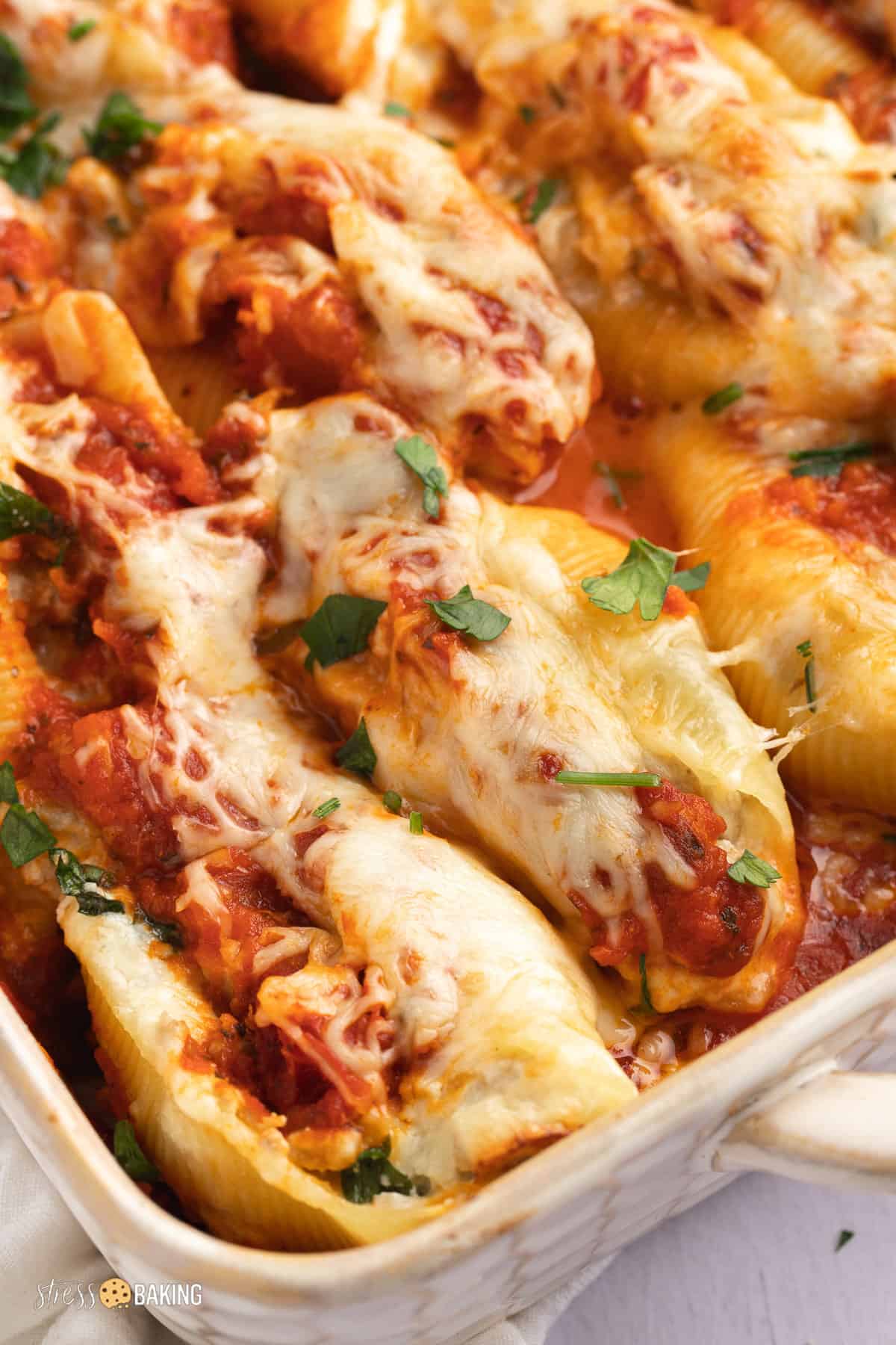 Golden cheesy stuffed shells topped with parsley