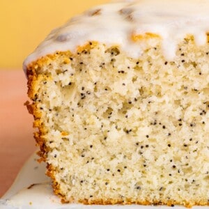 Close up of the inside of a lemon poppy seed loaf topped with a white glaze