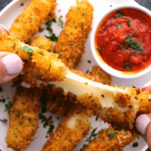 Golden mozzarella stick being pulled apart to show the melty cheese inside