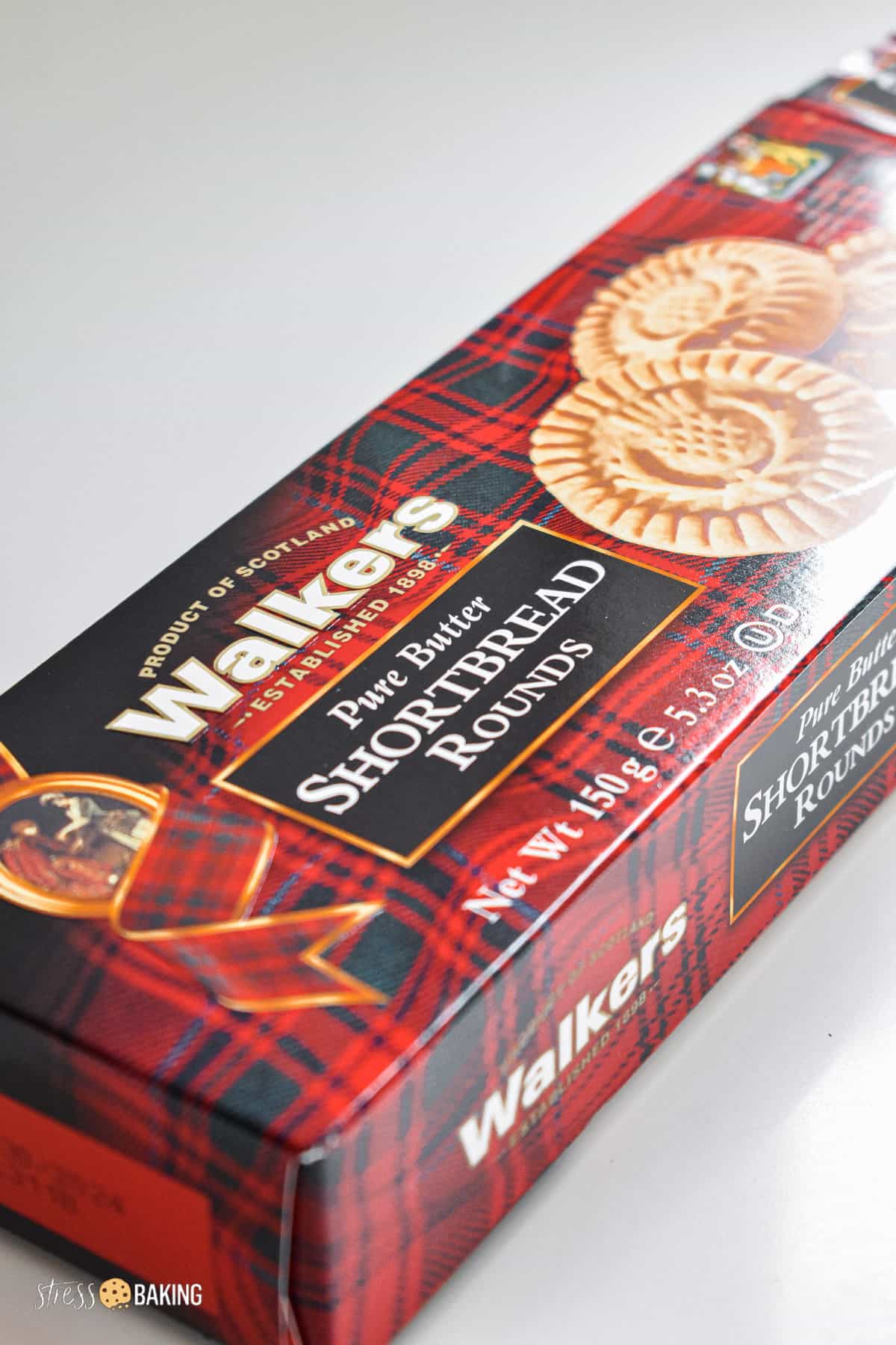 A red and black plaid box of Walkers Pure Butter Shortbread Rounds cookies