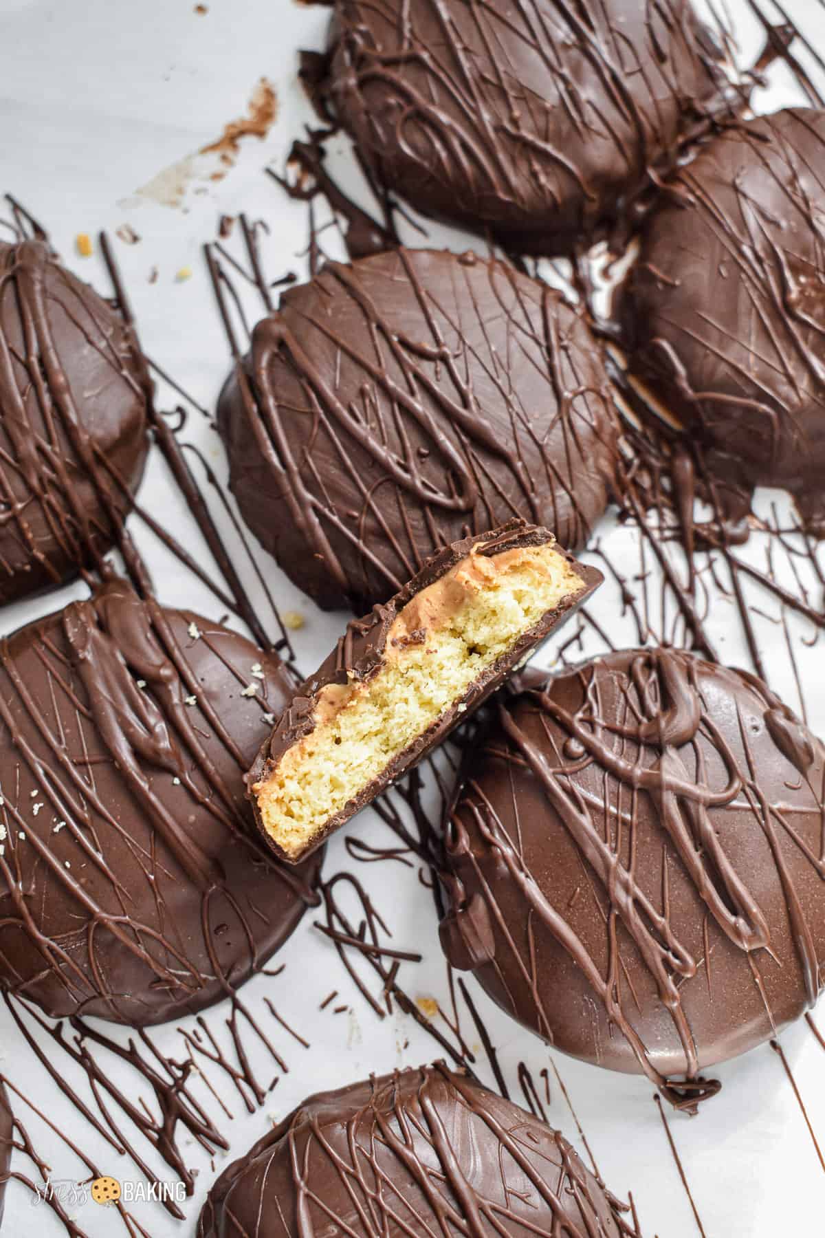 Shortbread cookie filled with peanut butter on top of other chocolate covered cookies