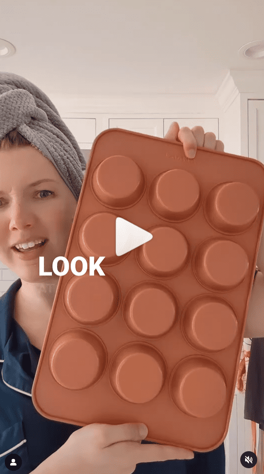 Screenshot of Leslie holding a coral colored Caraway muffin pan