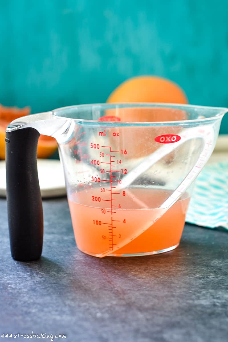 Grapefruit juice in a clear OXO measuring cup