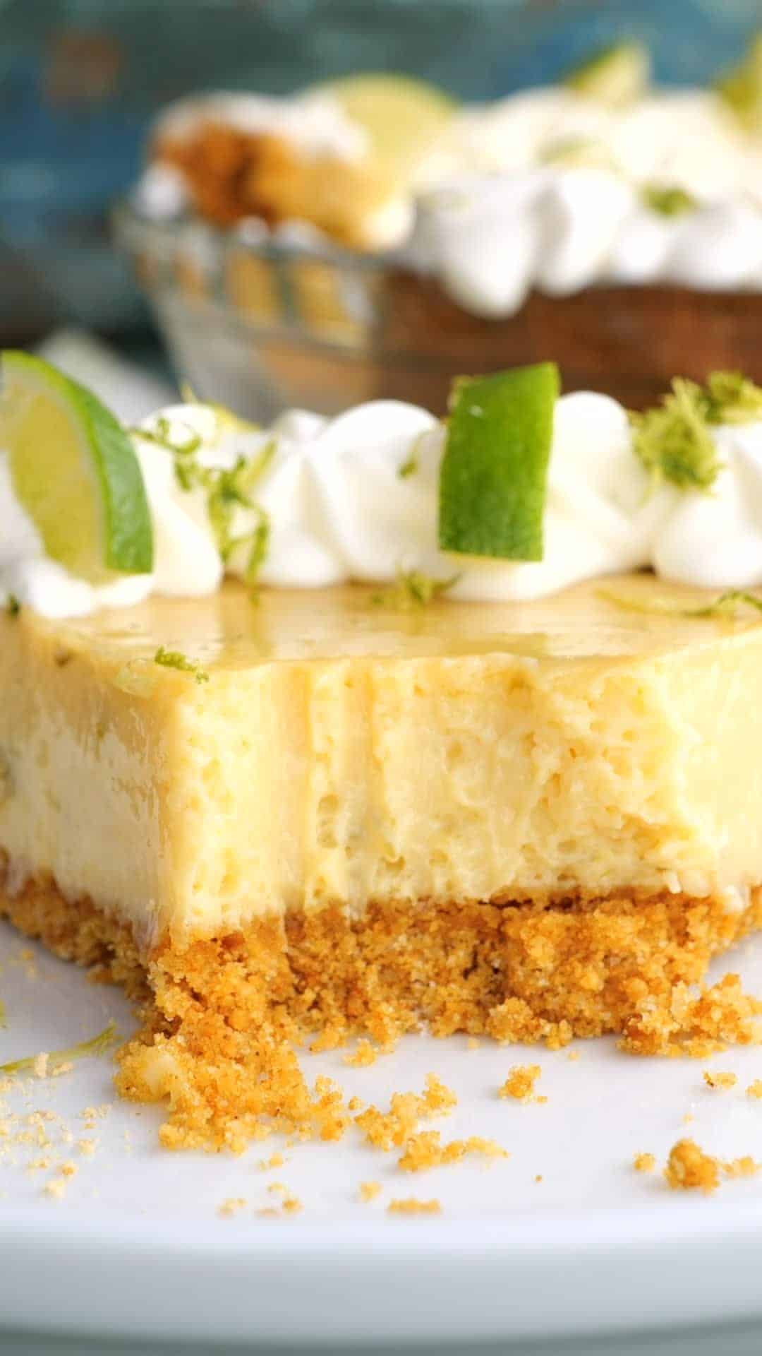 Key lime pie with a forkful taken out to reveal the creamy center and graham cracker crust