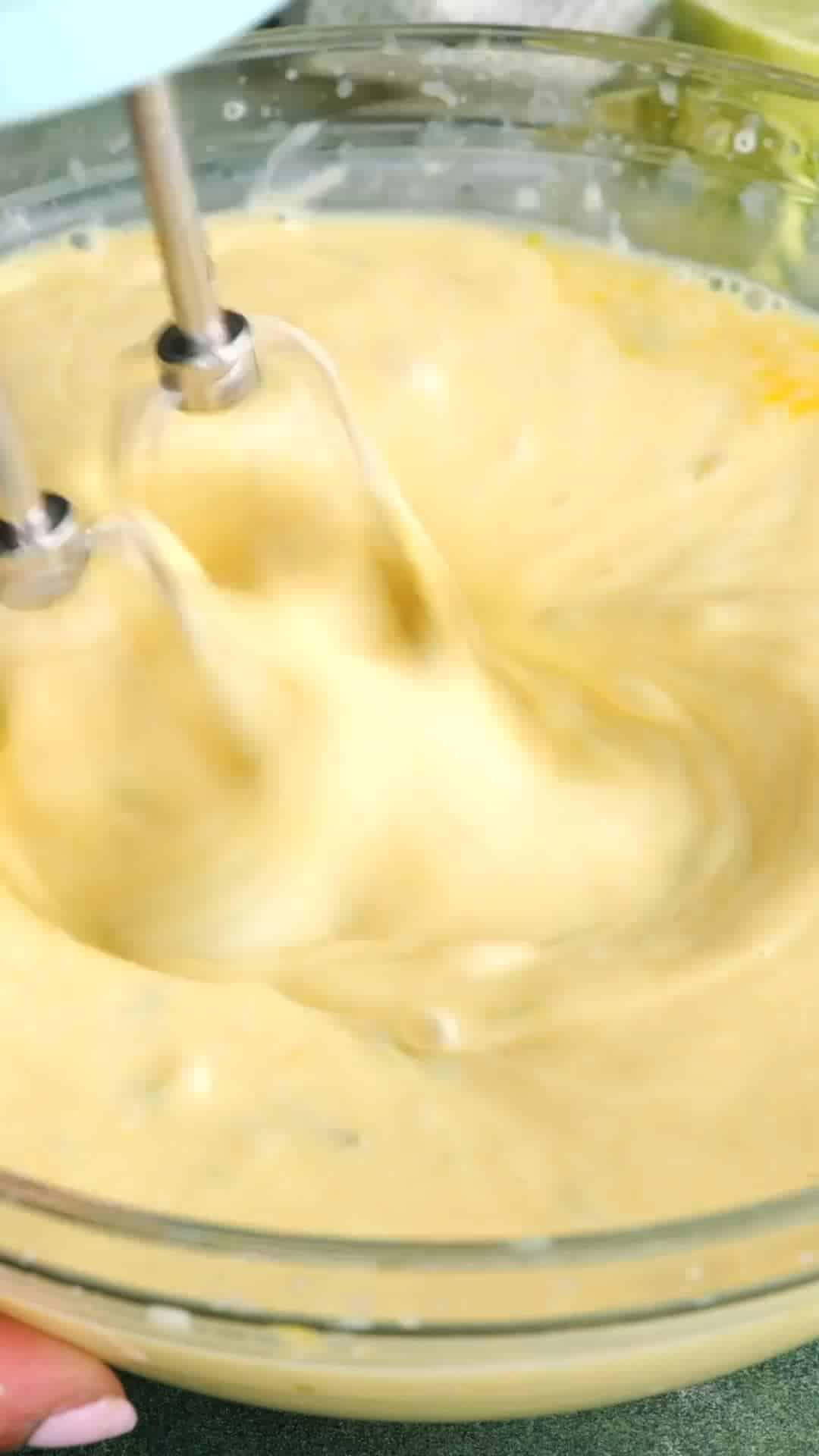 Key lime pie filling being beaten with a hand mixer