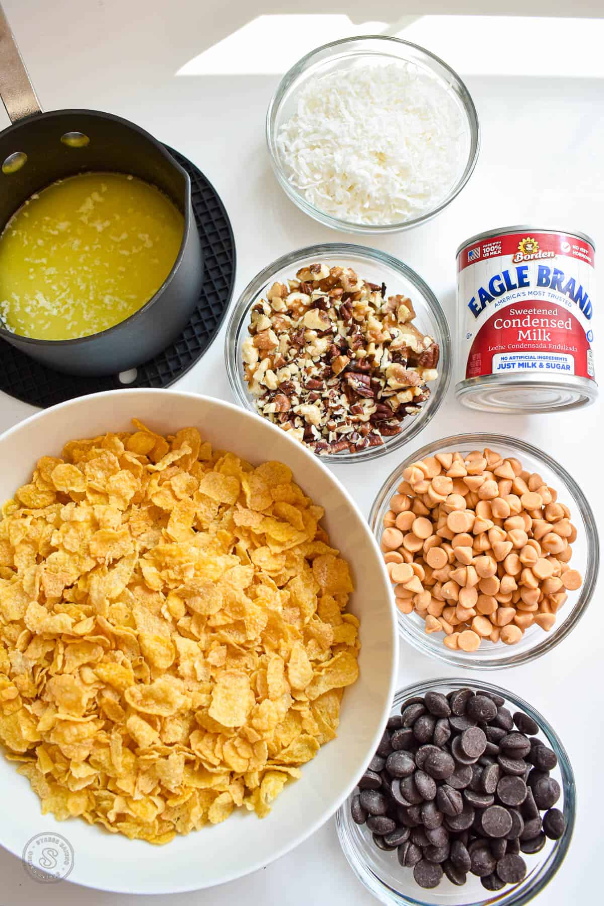 Ingredients for magic cookie bars on a white counter
