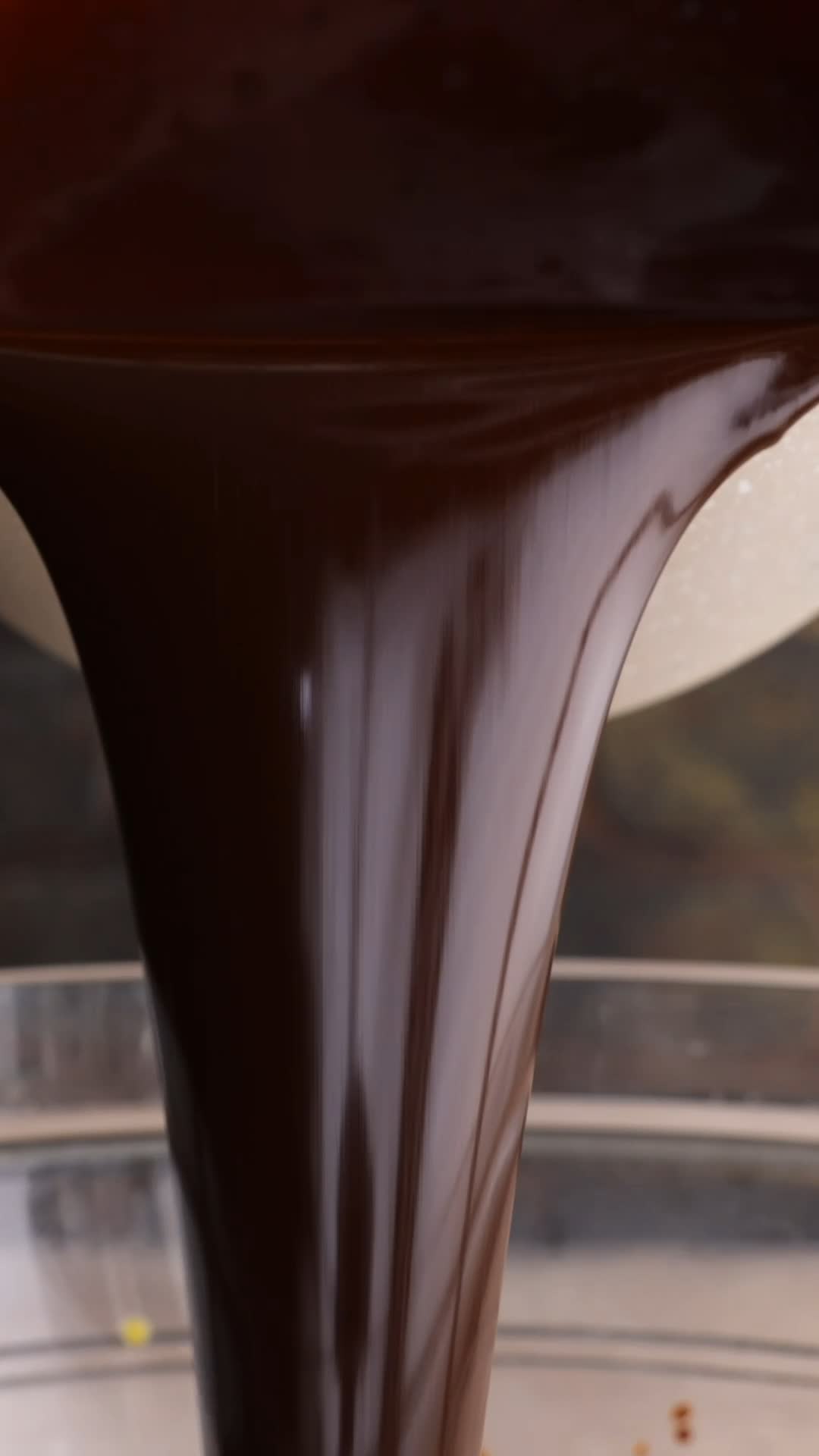 Smooth chocolate mixture being poured into a bowl
