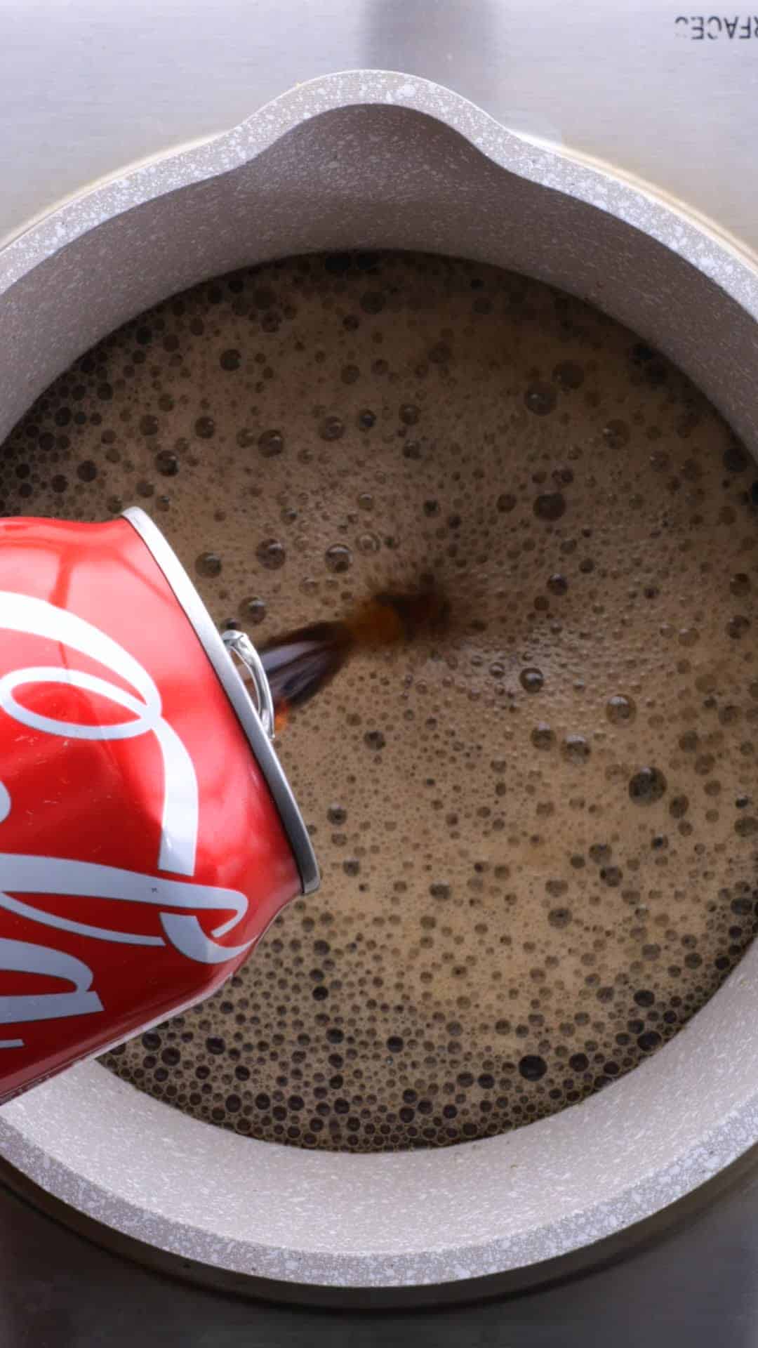 Coca-Cola being poured into a mixing bowl