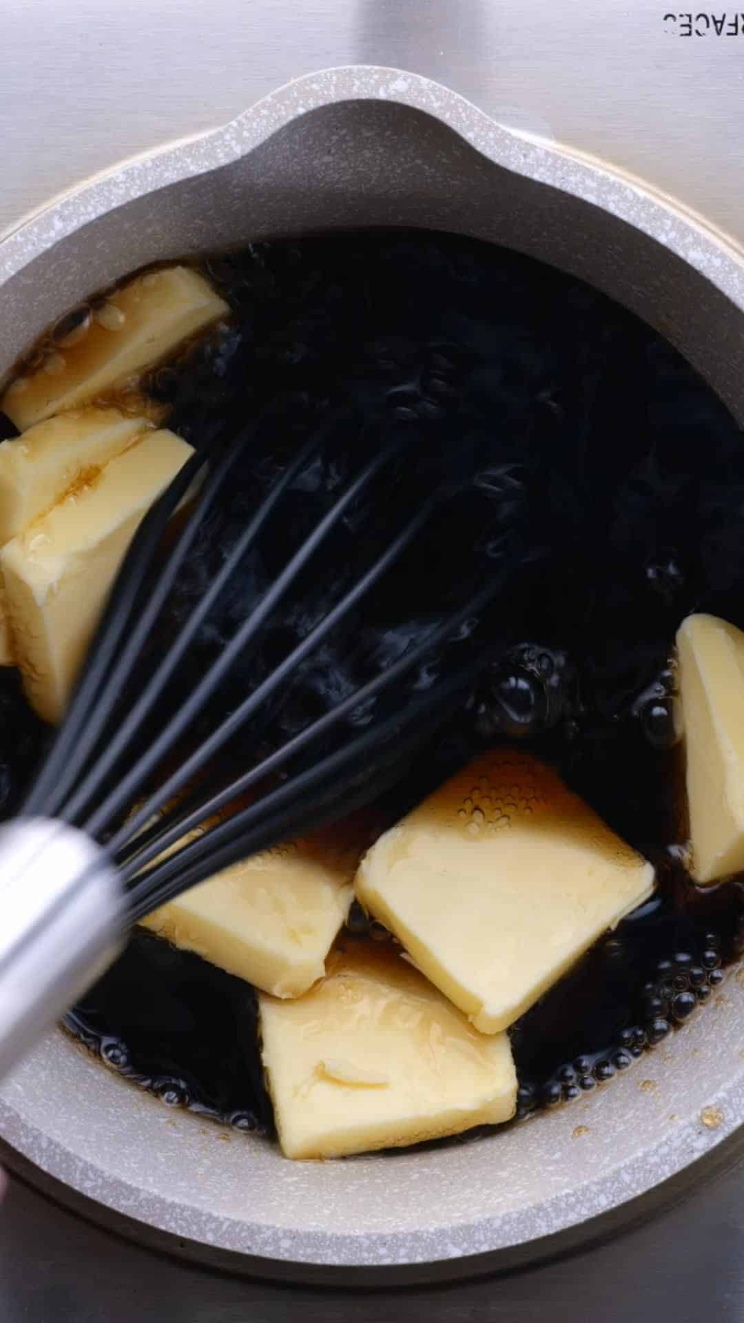 Cola and butter tabs being combined in a bowl