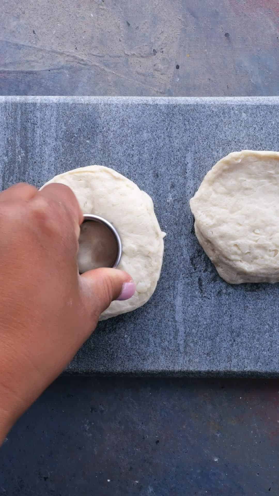 Canned biscuits having their centers removed on a slate surface