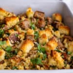 Golden brown stuffing in a white baking dish