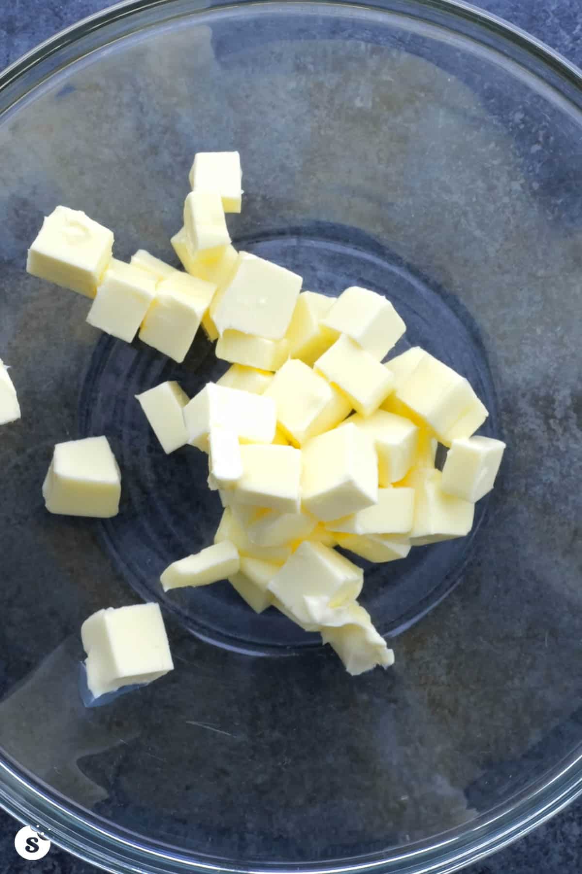Cubed butter in a clear glass bowl